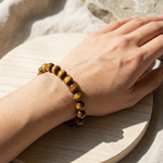 Hand wearing a tiger eye bracelet
